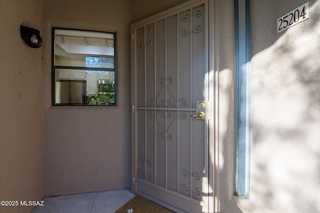property entrance featuring stucco siding
