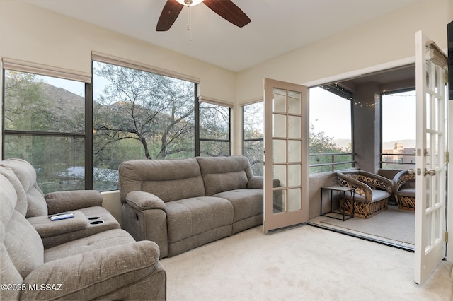 sunroom featuring french doors, ceiling fan, and an outdoor living space