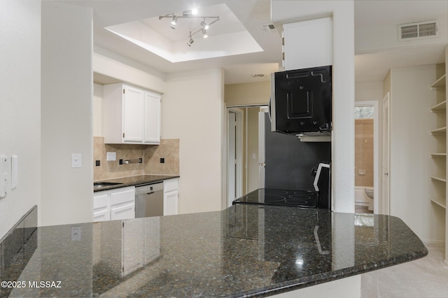 kitchen featuring stainless steel dishwasher, a raised ceiling, a peninsula, backsplash, and white cabinets