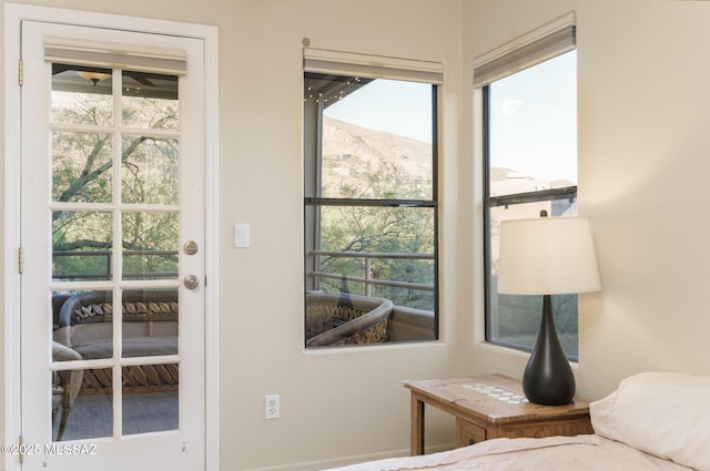 bedroom featuring multiple windows and a mountain view