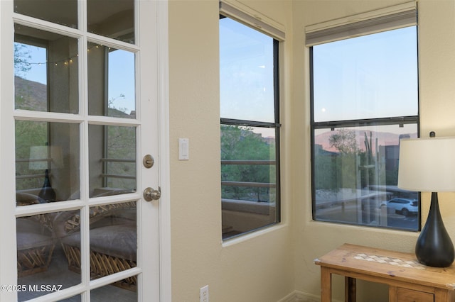 entryway with plenty of natural light, baseboards, and a textured wall