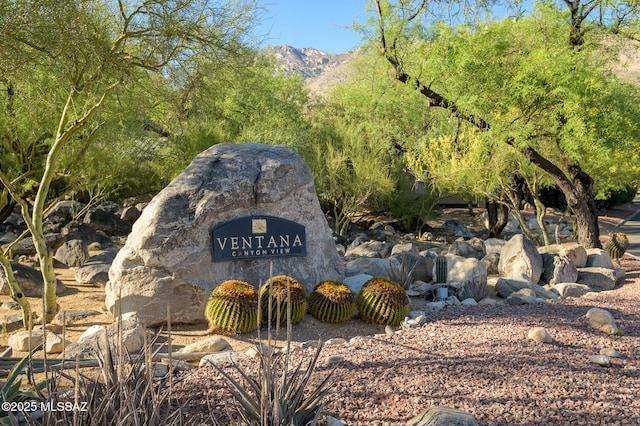 community sign with a mountain view
