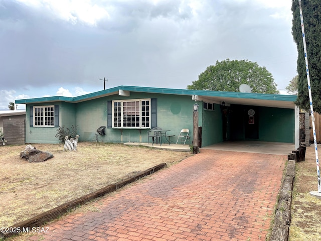 919 W 3rd Ave, San Manuel, AZ 85631 - ranch-style house with an attached carport, decorative driveway, and concrete block siding