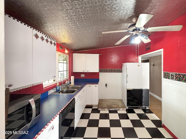 919 W 3rd Ave, San Manuel, AZ 85631 - kitchen with stainless steel microwave, freestanding refrigerator, dishwasher, a wainscoted wall, and a sink