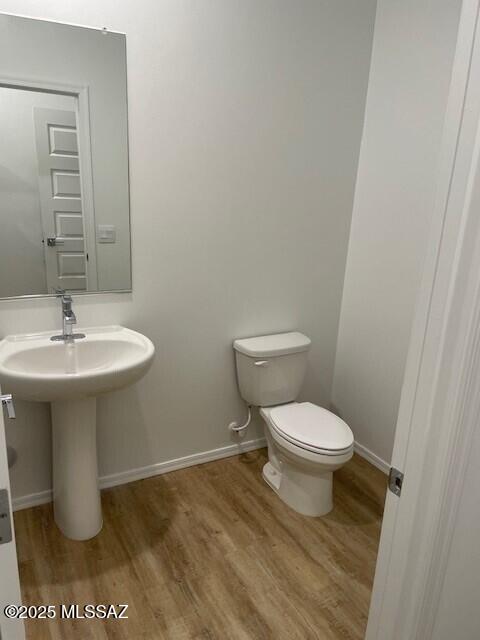 12203 E Patricia Ann Dr, Vail, AZ 85641 - bathroom with wood finished floors, toilet, and baseboards