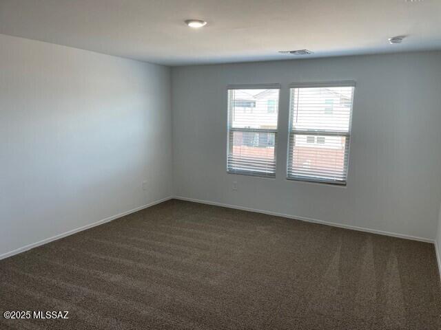 12203 E Patricia Ann Dr, Vail, AZ 85641 - spare room featuring dark colored carpet and baseboards