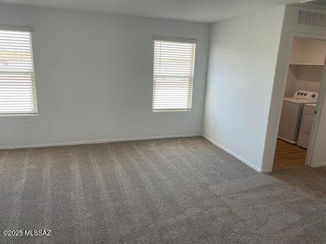 12203 E Patricia Ann Dr, Vail, AZ 85641 - unfurnished bedroom featuring washing machine and dryer, carpet floors, multiple windows, and baseboards