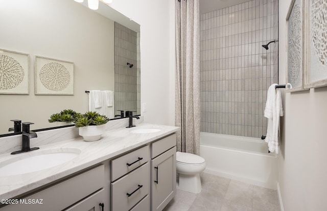 bathroom featuring toilet, shower / bath combo with shower curtain, double vanity, and tile patterned flooring