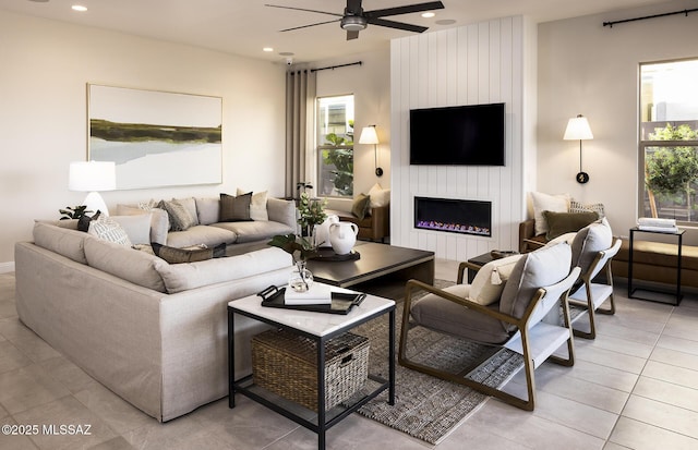 living room with ceiling fan, light tile patterned floors, recessed lighting, and a fireplace