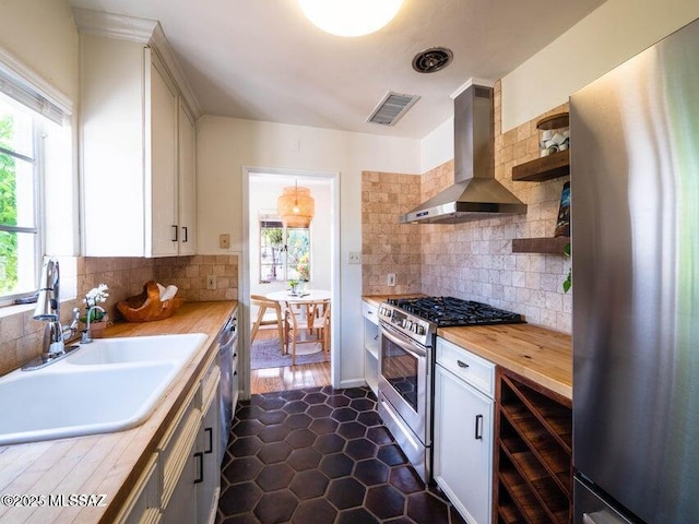 1700 N Winstel Blvd, Tucson, AZ 85716 - kitchen featuring stainless steel appliances, wall chimney exhaust hood, a sink, wine cooler, and backsplash