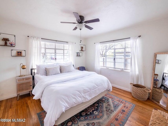 1700 N Winstel Blvd, Tucson, AZ 85716 - bedroom with baseboards, wood finished floors, and a ceiling fan