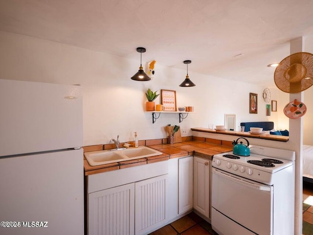 1700 N Winstel Blvd, Tucson, AZ 85716 - kitchen with white appliances, a sink, a peninsula, tile counters, and decorative light fixtures