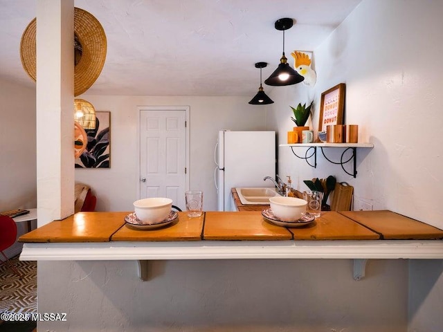 1700 N Winstel Blvd, Tucson, AZ 85716 - kitchen with freestanding refrigerator, a sink, and decorative light fixtures