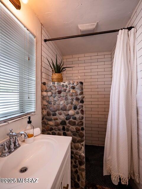1700 N Winstel Blvd, Tucson, AZ 85716 - full bathroom with a tile shower and vanity