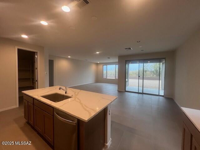 14385 N Saguaro Nest Trl, Marana, AZ 85658 - kitchen featuring a sink, stainless steel dishwasher, open floor plan, recessed lighting, and light stone countertops