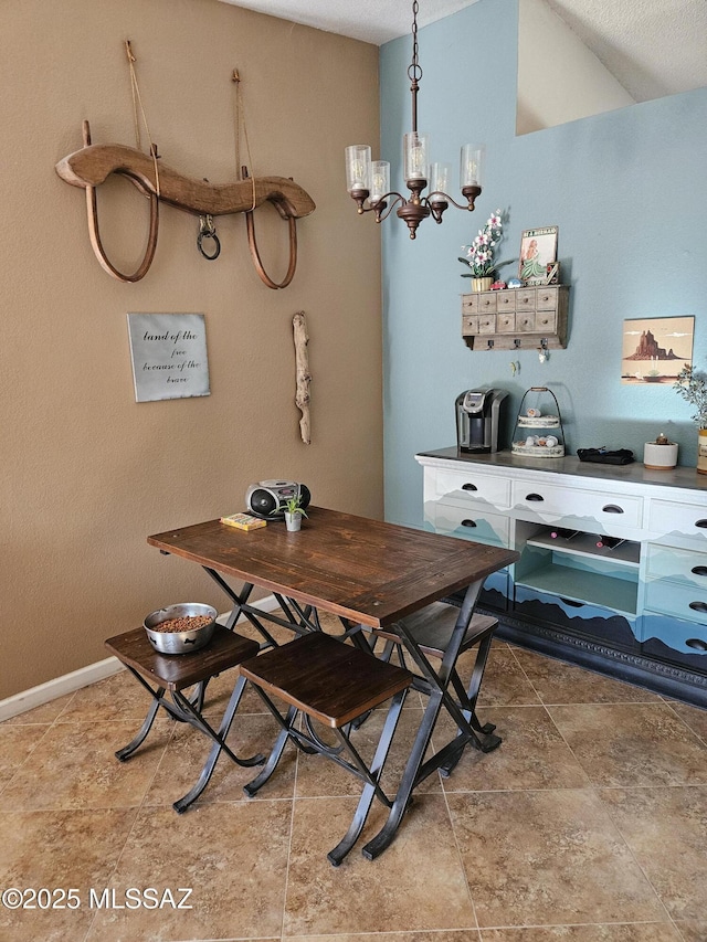dining room featuring a chandelier and baseboards