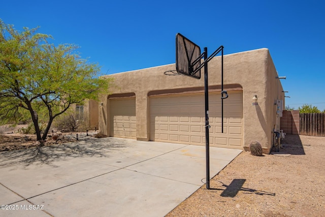 13940 E Hay Bale Trl, Vail, AZ 85641 - view of property exterior with stucco siding and fence