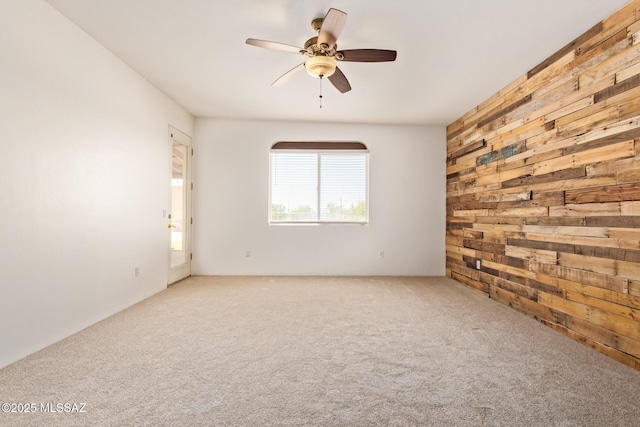 13940 E Hay Bale Trl, Vail, AZ 85641 - carpeted spare room featuring wooden walls and a ceiling fan