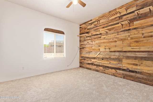 13940 E Hay Bale Trl, Vail, AZ 85641 - unfurnished room featuring wooden walls, carpet floors, and a ceiling fan