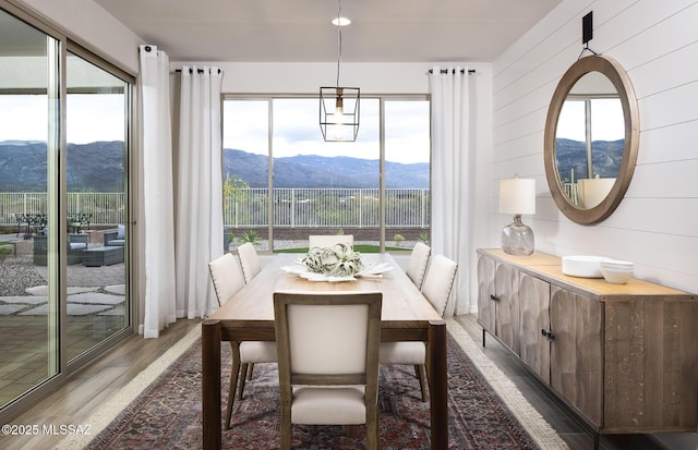 dining room with light wood-type flooring and a mountain view