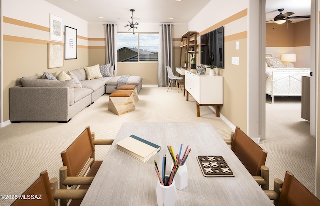 carpeted living room featuring a ceiling fan and baseboards