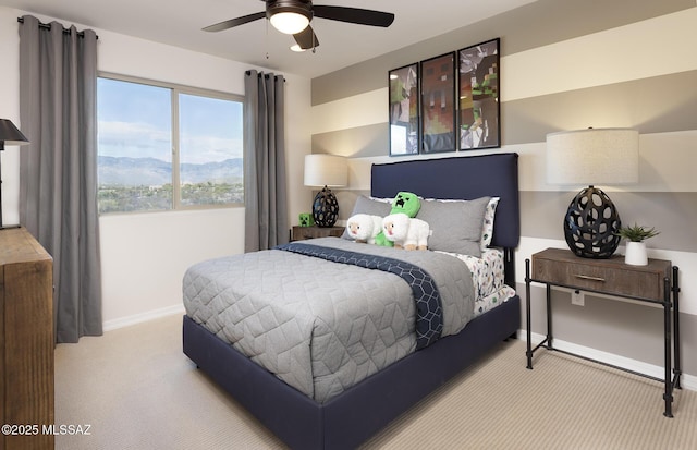 bedroom with carpet floors, baseboards, a mountain view, and ceiling fan