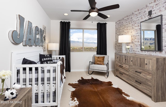 carpeted bedroom featuring a crib, baseboards, and recessed lighting