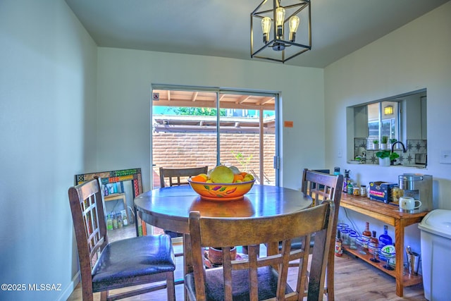 957 N Camino Las Solanas, Tucson, AZ 85710 - dining space with wood finished floors and a chandelier