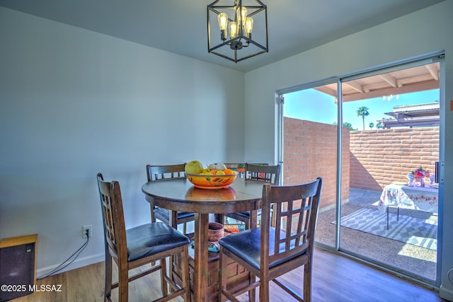 957 N Camino Las Solanas, Tucson, AZ 85710 - dining space with wood finished floors, a chandelier, and baseboards