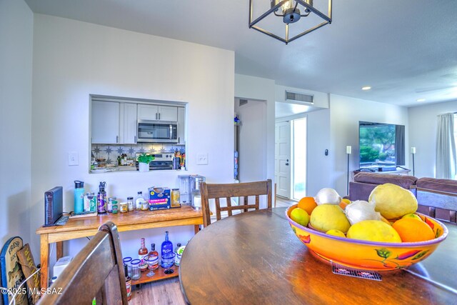 957 N Camino Las Solanas, Tucson, AZ 85710 - dining area with wood finished floors