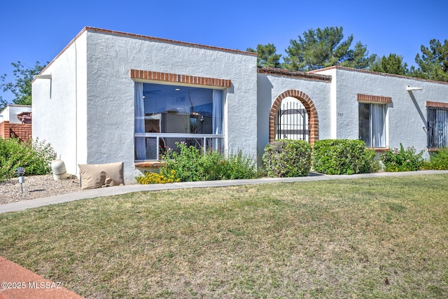 957 N Camino Las Solanas, Tucson, AZ 85710 - mediterranean / spanish-style house with a front yard and stucco siding