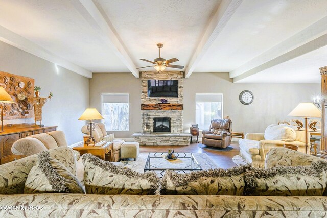 5800 N Placita Esplendora, Tucson, AZ 85718 - living area featuring a ceiling fan, plenty of natural light, wood finished floors, a fireplace, and beam ceiling
