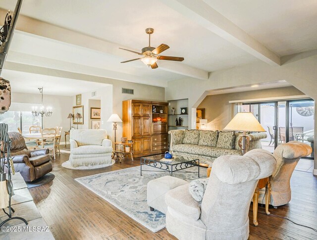 5800 N Placita Esplendora, Tucson, AZ 85718 - living area featuring ceiling fan, a chandelier, plenty of natural light, beam ceiling, and wood finished floors