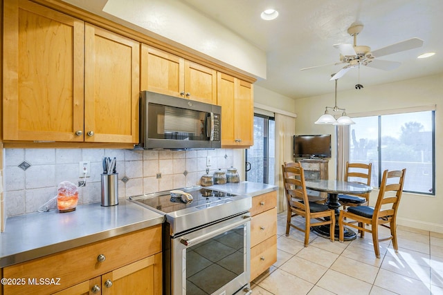 5800 N Placita Esplendora, Tucson, AZ 85718 - kitchen with stainless steel appliances, tasteful backsplash, light tile patterned floors, stainless steel countertops, and ceiling fan