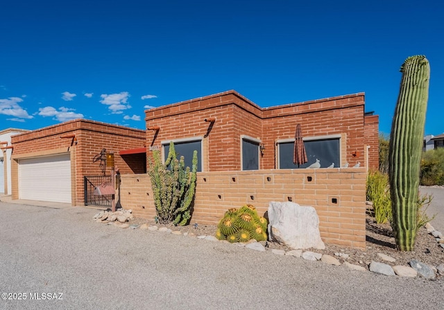 5800 N Placita Esplendora, Tucson, AZ 85718 - view of front of home featuring fence, a garage, and brick siding