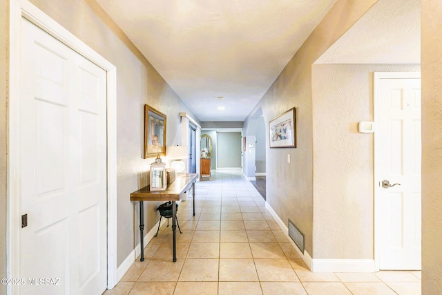 5800 N Placita Esplendora, Tucson, AZ 85718 - hallway featuring light tile patterned floors, a textured wall, and baseboards