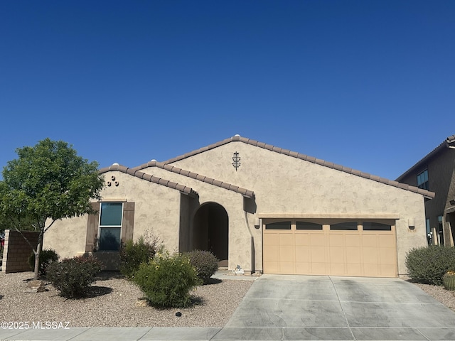 11749 N Key Lime Pl, Oro Valley, AZ 85742 - mediterranean / spanish-style home with an attached garage, concrete driveway, stucco siding, and a tile roof