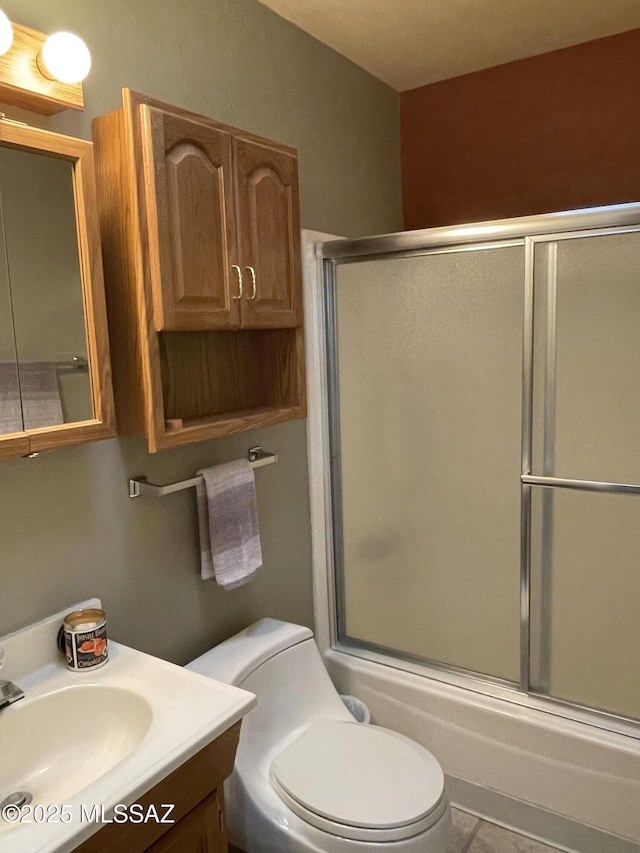 360 W Camino Del Sonador, Green Valley, AZ 85614 - bathroom featuring shower / bath combination with glass door, vanity, and toilet