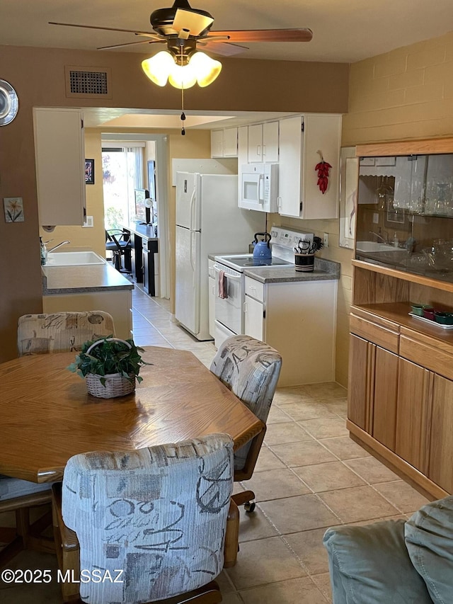 360 W Camino Del Sonador, Green Valley, AZ 85614 - kitchen featuring white appliances, ceiling fan, light tile patterned floors, a sink, and white cabinetry