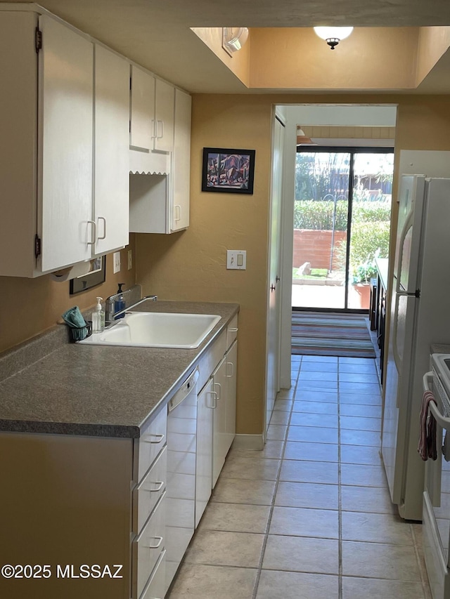 360 W Camino Del Sonador, Green Valley, AZ 85614 - kitchen with a sink, light tile patterned floors, white appliances, and white cabinets