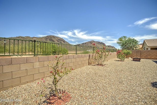 9752 N Saguaro Breeze Way, Marana, AZ 85653 - fenced backyard featuring an outdoor fire pit and a mountain view