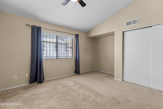 4765 S Windrose Dr, Tucson, AZ 85730 - unfurnished bedroom with a textured ceiling, carpet, lofted ceiling, a closet, and ceiling fan