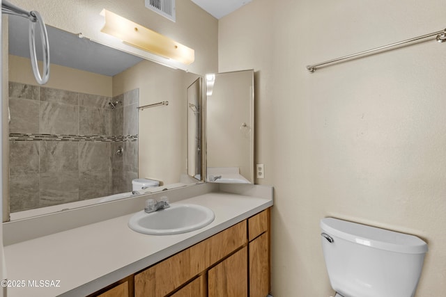 4765 S Windrose Dr, Tucson, AZ 85730 - full bathroom featuring toilet, vanity, and a tile shower