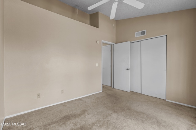 4765 S Windrose Dr, Tucson, AZ 85730 - unfurnished bedroom with carpet, baseboards, a closet, high vaulted ceiling, and a textured ceiling