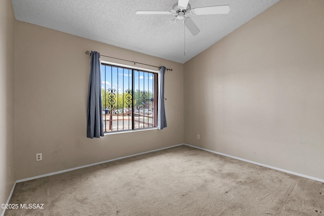 4765 S Windrose Dr, Tucson, AZ 85730 - carpeted spare room featuring a textured ceiling, vaulted ceiling, ceiling fan, and baseboards