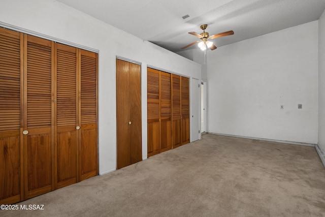 4765 S Windrose Dr, Tucson, AZ 85730 - unfurnished bedroom with multiple closets and carpet