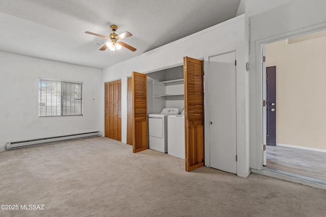 4765 S Windrose Dr, Tucson, AZ 85730 - unfurnished bedroom featuring a baseboard radiator, washing machine and clothes dryer, carpet floors, multiple closets, and a textured ceiling