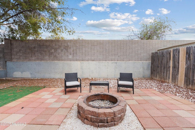4765 S Windrose Dr, Tucson, AZ 85730 - view of patio / terrace featuring a fire pit and a fenced backyard