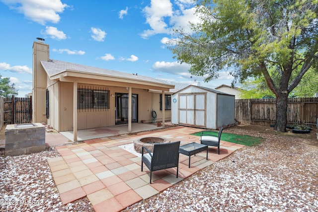 4765 S Windrose Dr, Tucson, AZ 85730 - rear view of property featuring a fire pit, a patio area, a shed, and a chimney