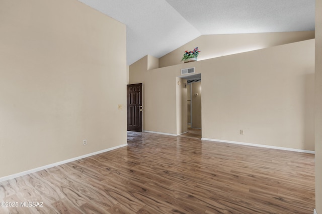 4765 S Windrose Dr, Tucson, AZ 85730 - unfurnished room featuring wood finished floors, high vaulted ceiling, and baseboards